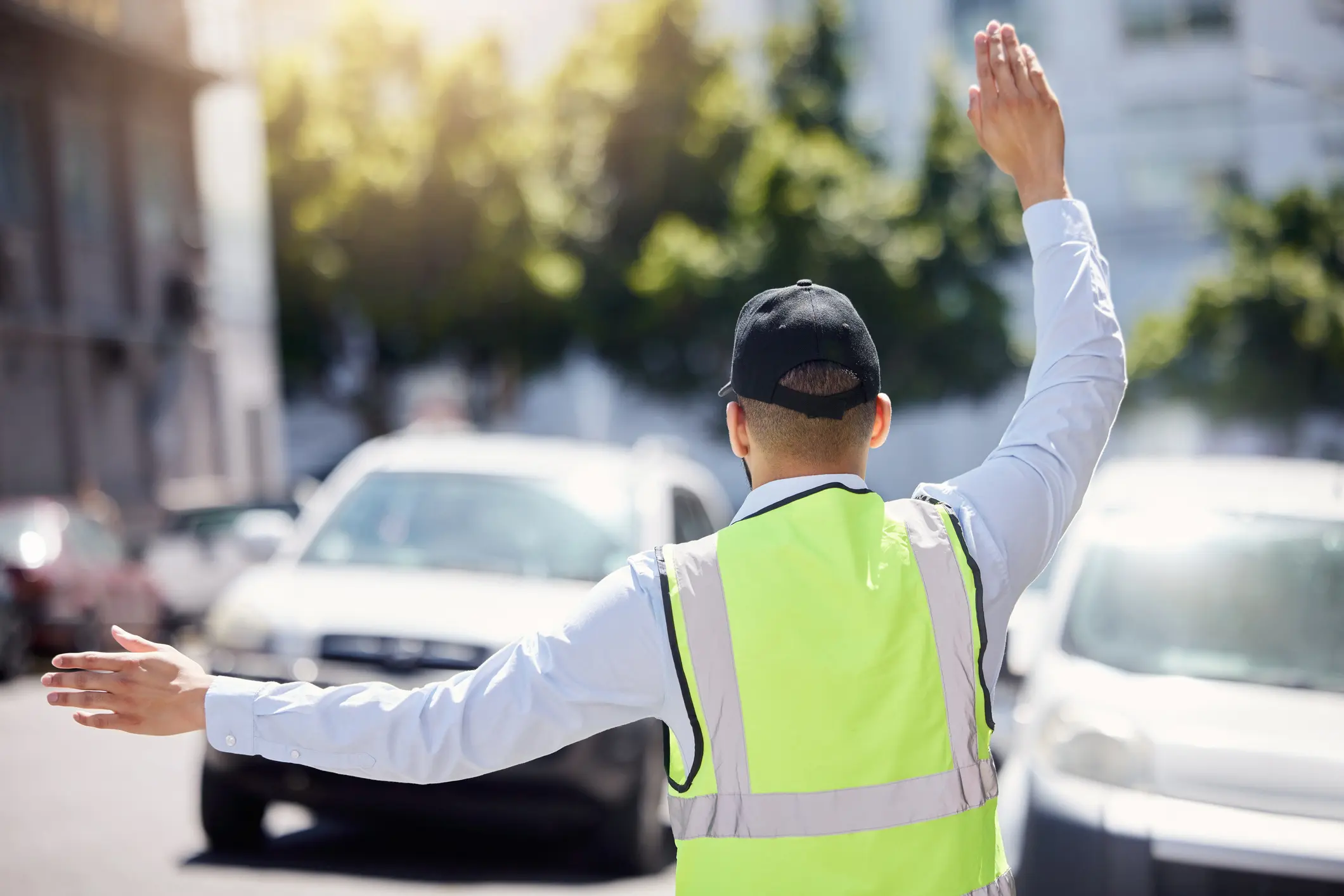 Traffic officer directing vehicles in daylight.