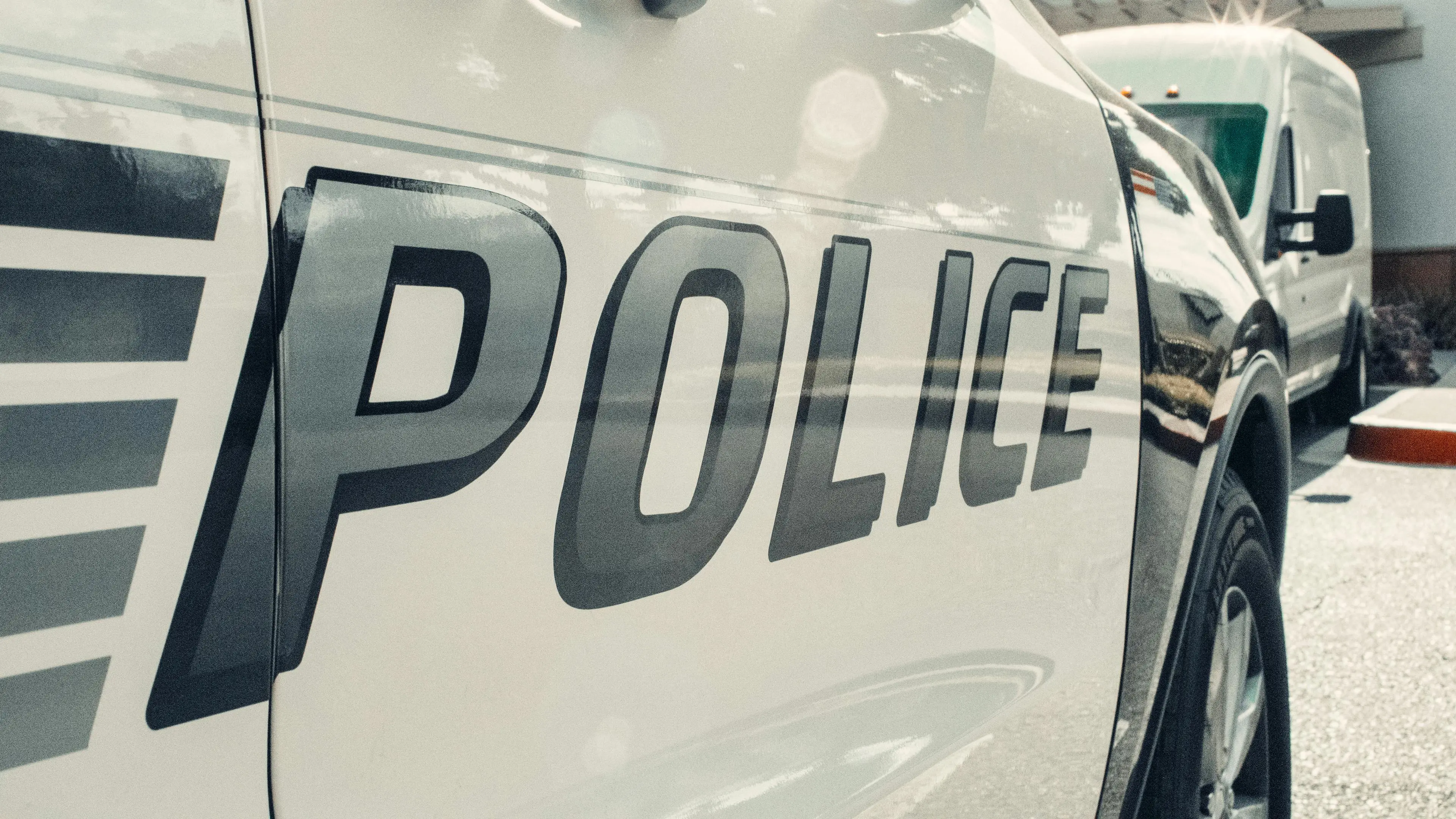 Close-up of the word 'POLICE' on a white vehicle.